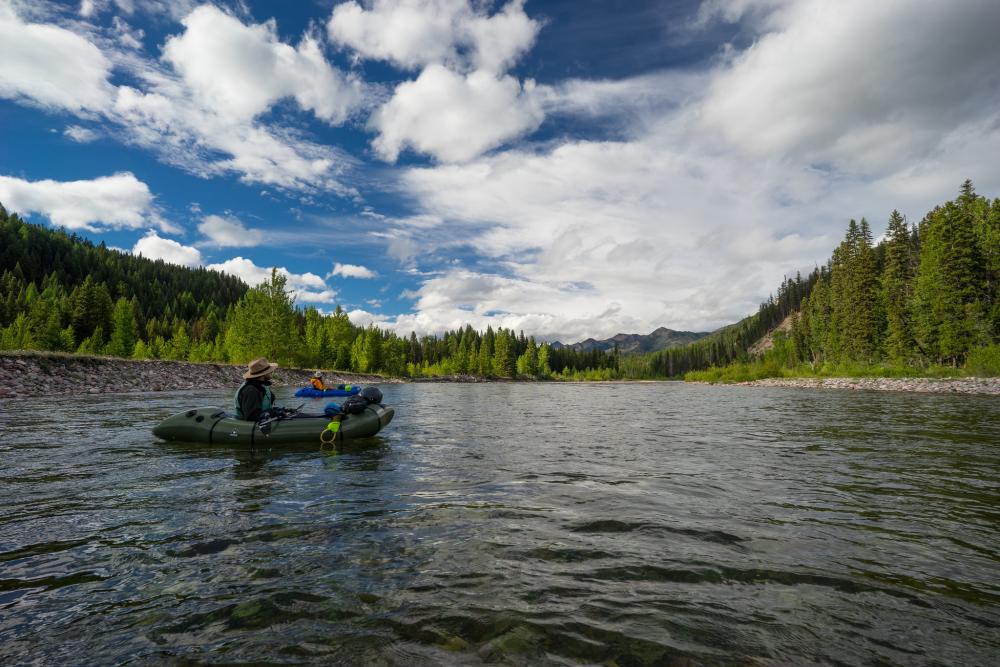 Two people packrafting the South Fork of the Flathead River in the Bob Marshall Wilderness Complex, Montana